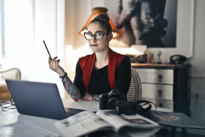 informal adult woman using laptop for working with photo project